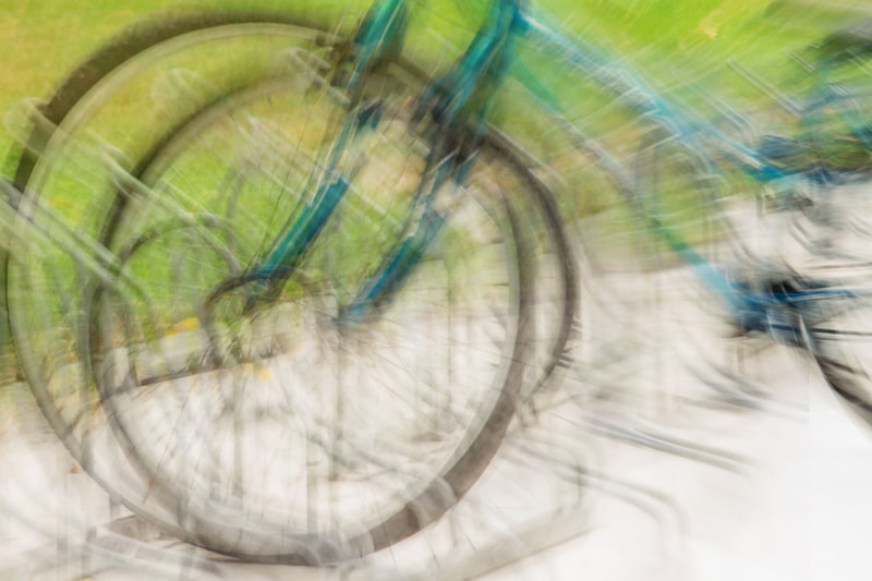 Impressionistic photograph of a bicycle left in a bike stand.